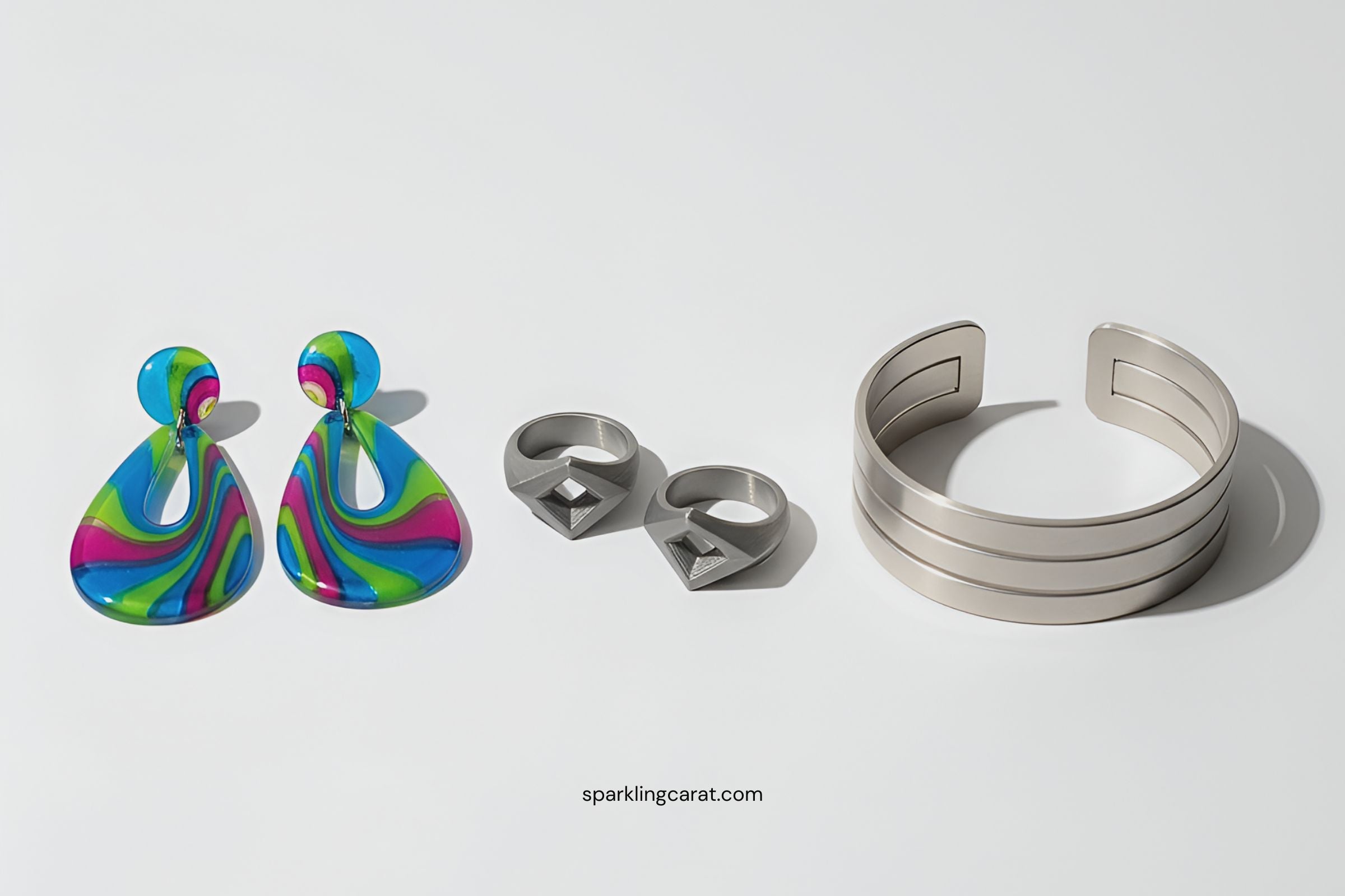 Jewelry made from bio-resins, 3D-printed metals, and recycled alloys displayed together.