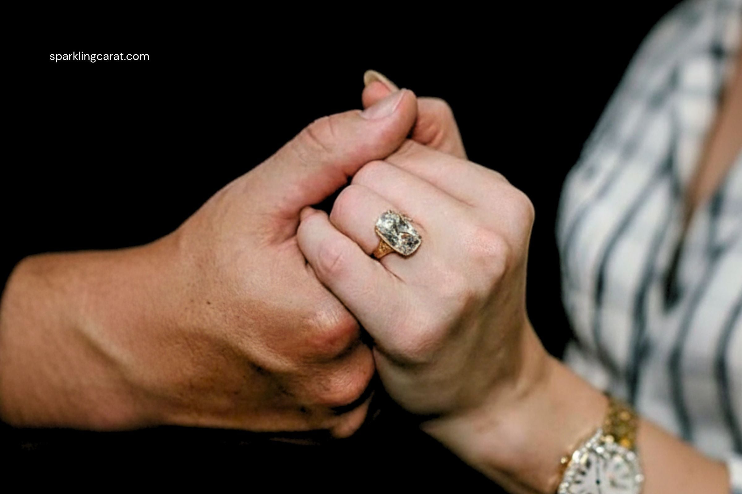 Taylor Swift’s vintage-style engagement ring with an old mine–cut diamond bezel-set in yellow gold, shown with intricate filigree and side stones.
